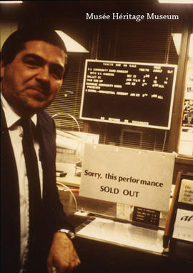 Gerry Buccini standing by sold-out sign