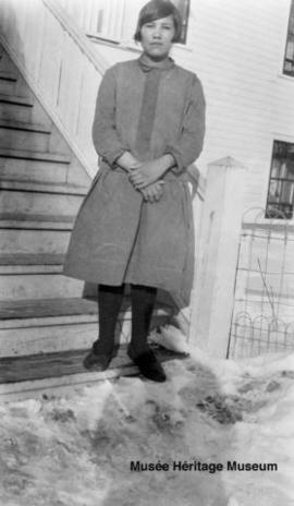 Monica Whitstone in front of 3rd residential school at Onion Lake, Saskatchewan