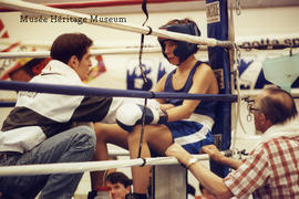 Boxer sitting at ringside with coach for finals